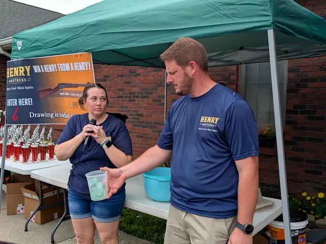 Henry Brothers team drawing raffle tickets at their booth during a Jeffersonville, Indiana community event