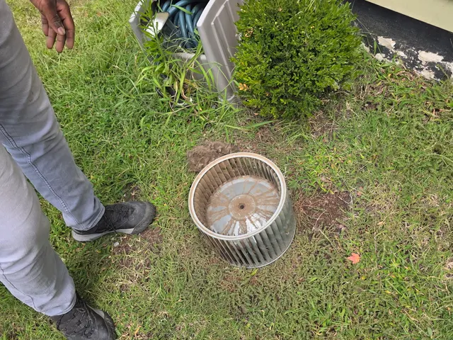 Dirty centrifugal blower wheel pulled from an air handler for cleaning during a Henry Brothers maintenance visit