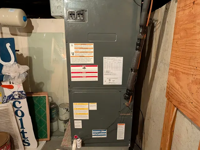 Existing basement air handler with a Honeywell control before system replacement