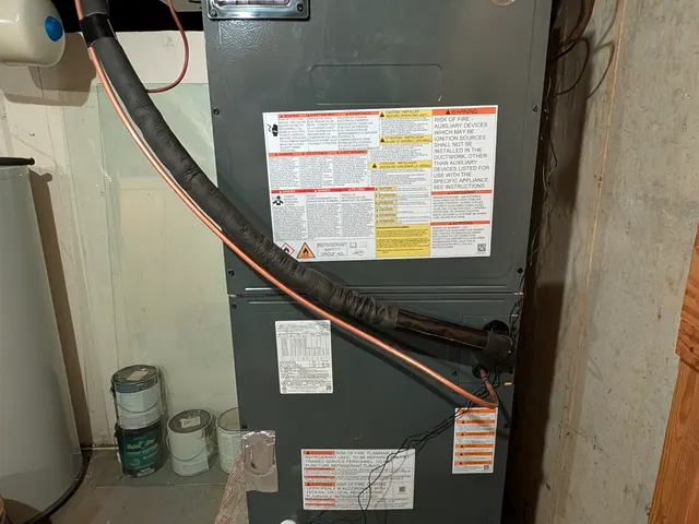 New air handler in basement with Honeywell Home control mounted on the supply plenum after HVAC install