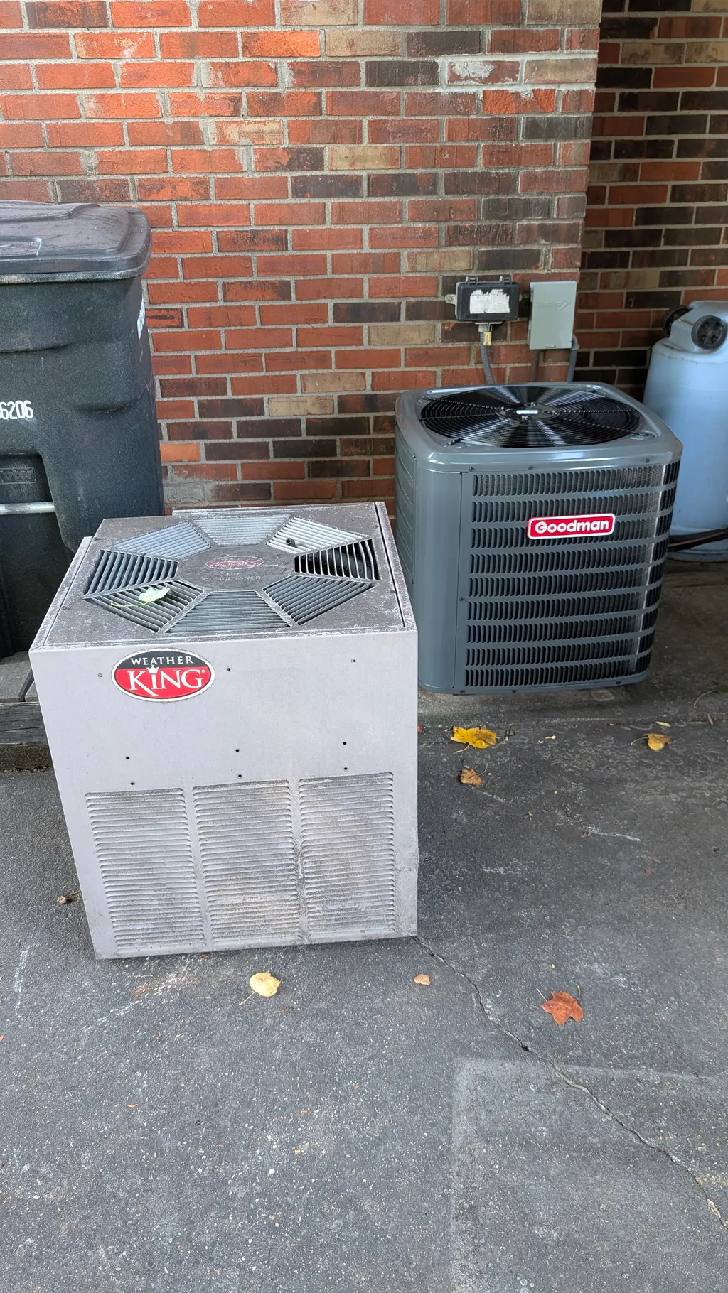 Old Weather King and Goodman central AC condensers side by side during Jeffersonville HVAC repair job