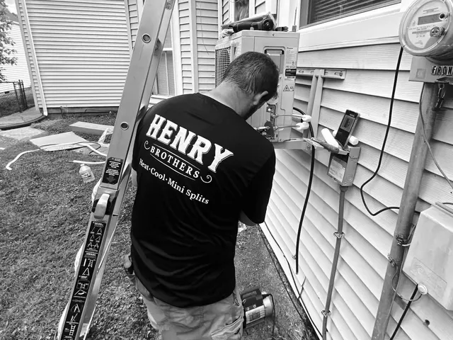 Henry Brothers technician running line set on home exterior during mini-split installation