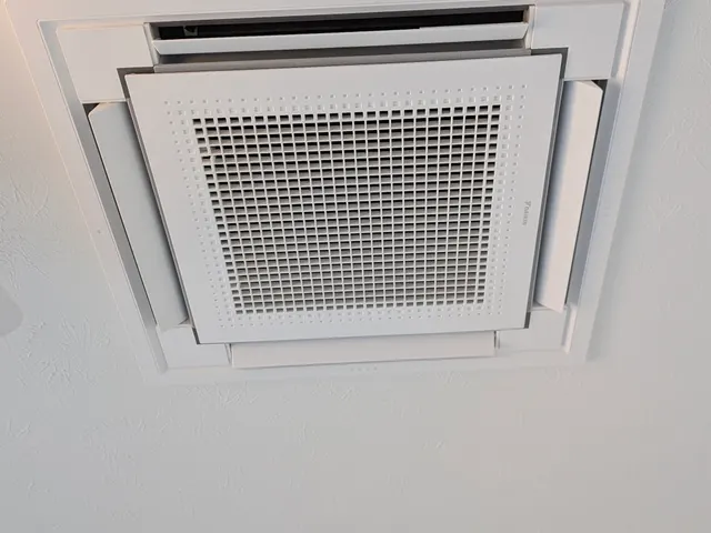 Daikin ceiling cassette mini split indoor unit installed flush in a white textured ceiling