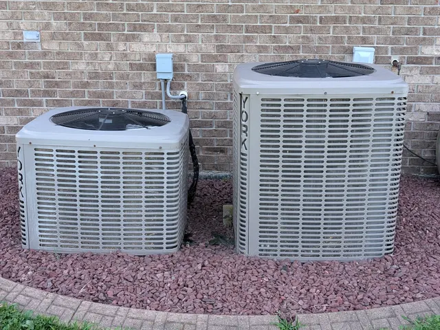 Two existing York central AC condensers before mini-split installation in Clark County Indiana