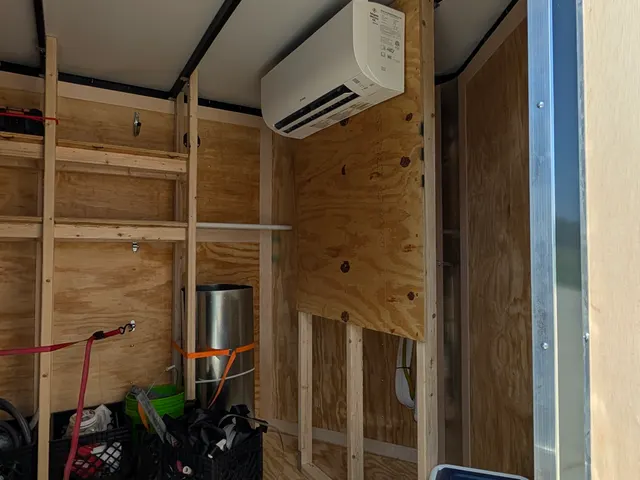 Mini-split wall-mount indoor unit installed inside Henry Brothers work trailer