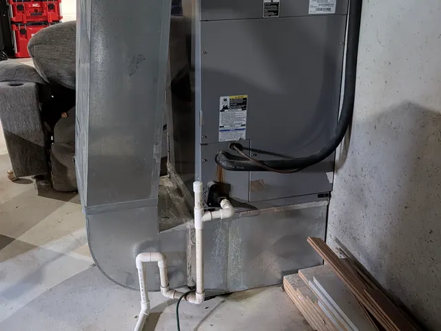 Full view of Bryant air handler with ductwork and condensate drain Memphis Indiana basement