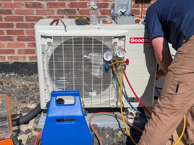 Technician charging Goodman mini-split outdoor condenser with refrigerant gauges Memphis Indiana