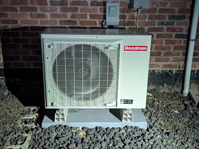 Completed Goodman mini-split outdoor unit illuminated at night Memphis Indiana after install