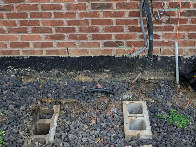 Concrete support blocks and disconnected electrical whip left after old AC condenser removal, Memphis Indiana