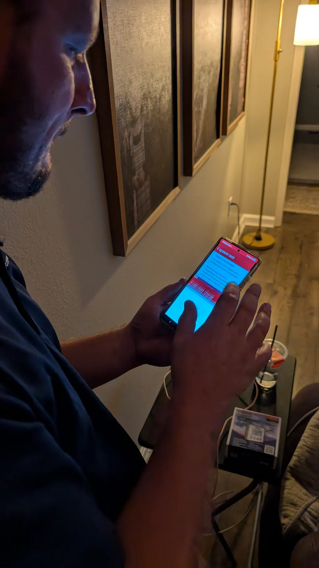Henry Brothers HVAC technician reviewing system test results on phone Memphis Indiana