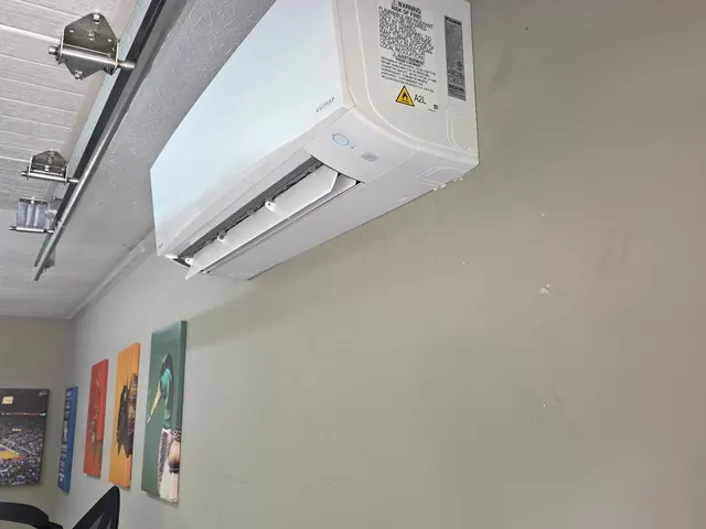 Completed mini-split indoor unit installed on garage wall with cover on after installation