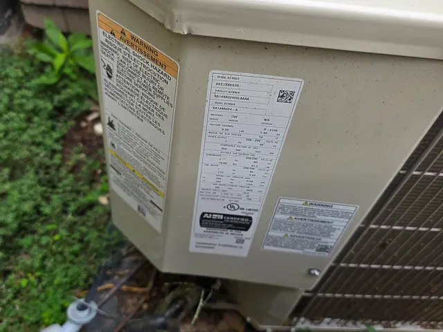 Central AC condenser data plate showing model and serial number recorded during an HVAC second opinion inspection