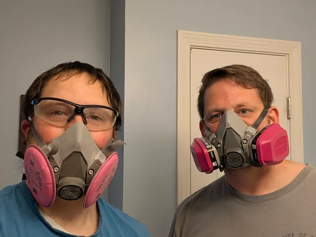 Henry Brothers technicians in 3M half-mask respirators on a Clarksville, Indiana job site